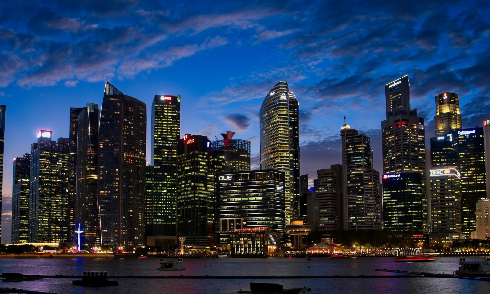 Spectacular view of Singapore's skyline with illuminated skyscrapers against a twilight sky.